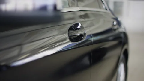 Close-up of car door handle opened by man in auto dealership. Owner sitting into Stock Footage 127995338