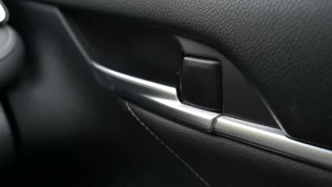 Close-up of a car door lock engaging with an audible click 库存影片 323249398