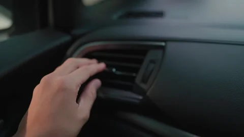 Close-up of a car driver or passenger warming hands in the car with the help  Stock Footage 264105375