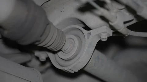Close-up of a car driveshaft center support bearing and rubber boot. Stock Footage 345912845