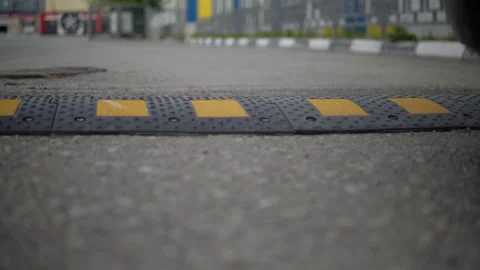 Close-up of a car driving through an artificial bump Stock Footage 135348306
