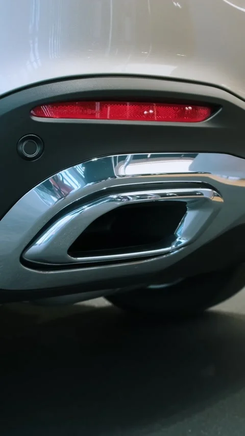 Close-up of car dual exhaust tips and rear diffuser with chrome surrounds on Stock Footage 339364924