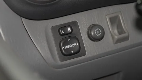 A close up of a car electric side mirror control switch. Stock Footage 342730168
