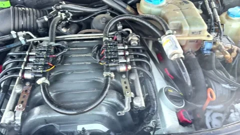 Close-up of a car engine bay with aftermarket gas injection components, hoses Stock Footage 333309272