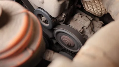 Close-up of car engine belt system in motion Stock Footage 345262699