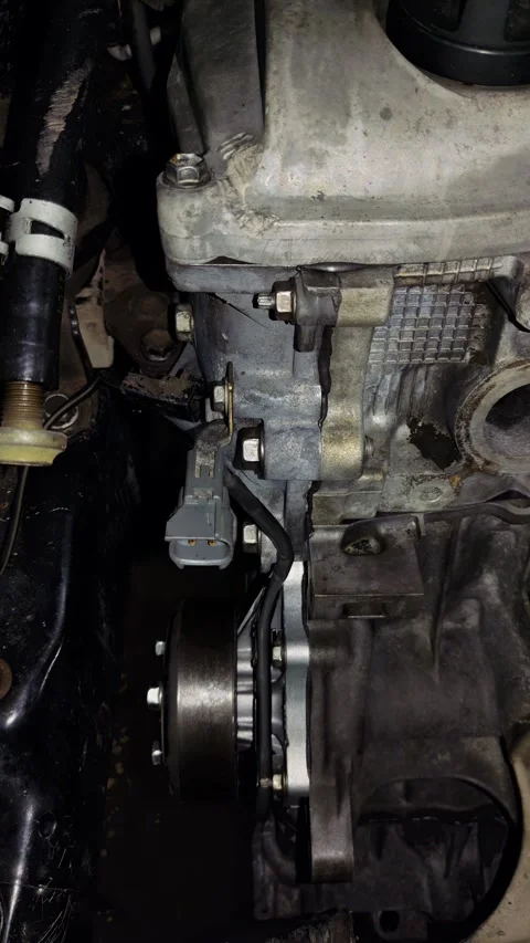 Close-up of a car engine block side view with electrical sensors and pulley Stock Footage 340414691