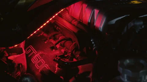 Close-up of a car engine with red LED lights illuminating the components Stock Footage 288781406