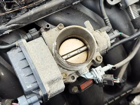 Close-up of a car engine throttle body showing the butterfly valve, electro.. Stock Photos