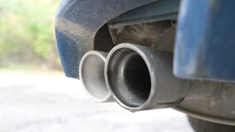 Close-up of a car exhaust during engine revving, with vibrations and droplets of Video stock 323249887