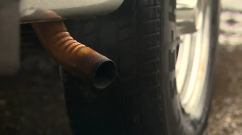 Close-up of car exhaust pipe emitting smoke Stock Footage 59513550