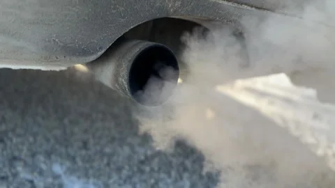 Close up of a car exhaust pipe emitting thick smoke. Stock Footage 328446589