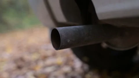 Close-up of a car exhaust pipe shaking as the engine revs Video stock 323246535