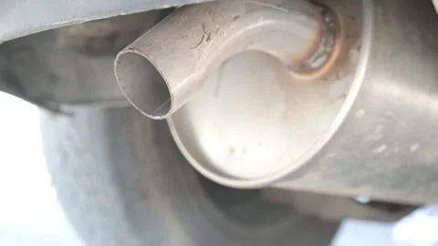 Close-up of a car exhaust pipe shaking as the engine revs Video stock 323248149