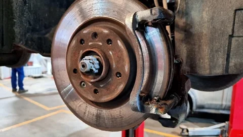 Close Up of Car Front Brake Disc, Caliper, and Wheel Hub Assembly Stock Footage 331978810