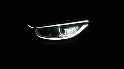 Close up of car front IQ Led Light with a Black Background. Headlight turning Stock Footage 252830534