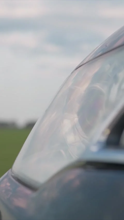Close up of car headlight with soft evening reflections on glass surface against Stock Footage 348239528