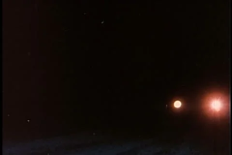 Close-up of car with headlights coming to a stop Stock Footage 11354163