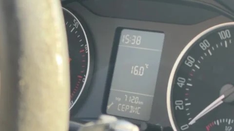 Close-up of a car instrument cluster showing speedometer, digital clock, fuel Stock Footage 337113796
