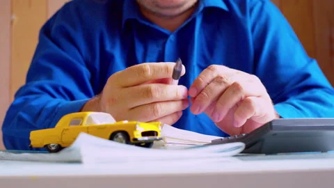 Close up of car insurance agent spinning pen at desk. Stock Footage 337664795