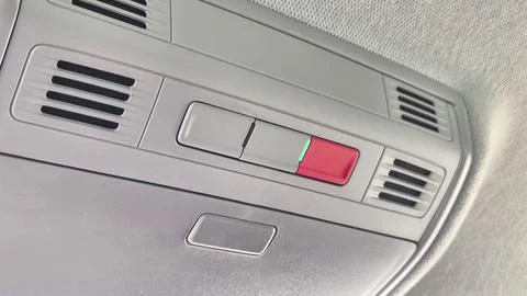 Close-up of car interior controls featuring a red and green indicator button 스톡 사진