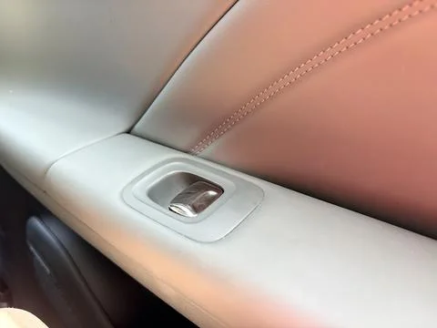 Close-Up of Car Interior Door Handle and Leather Upholstery Photos
