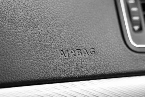 Close up of car interior panel with airbag sign on it. Leather texture and Stock Photos