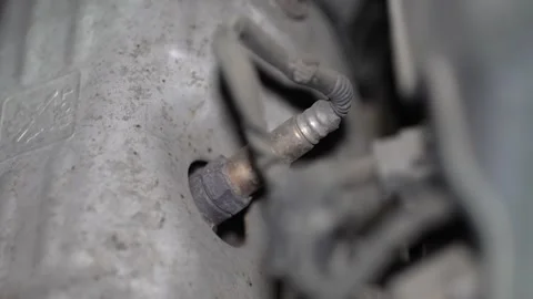 Close-up of a car lambda oxygen sensor in exhaust manifold. Stock Footage 345911552