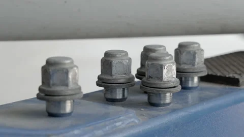 Close up of car lug nuts on a blue steel bar waiting to be put back on Stock Footage 239743490