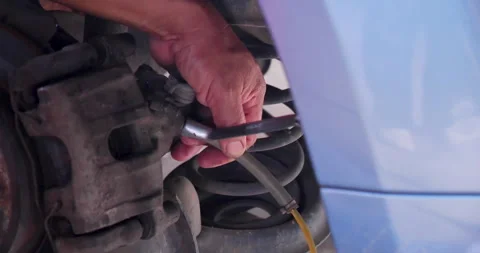 Close up Car Mechanic man hands repairing car auto repair shop. Man hands fixing Stock Footage 288787696