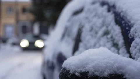 A close-up of a car mirror covered in snow on a snowy winter day. Snowfall. Stock Footage 325367256