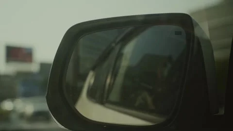 Close-up of car mirror view while driving in city of Bangkok Thailand daytime Stock Footage 303226395