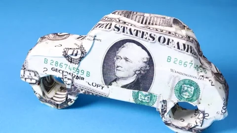 Close-up car model made with dollar banknote rotating on a board Video stock 248387521