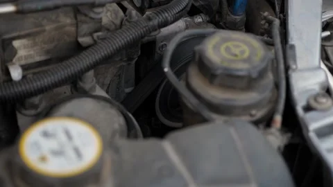 Close-up of a car with an open hood and a working timing belt at a car station. Stock Footage 297844183