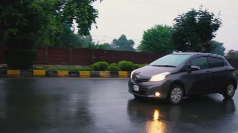 Close up of a car passing by on rainy road at morning Stock Footage 138734719
