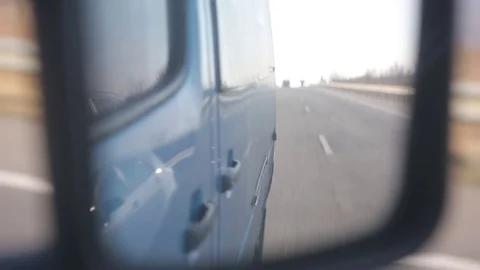Close-up of car rear view mirror. the road is reflected in the car mirror Stock Footage 71975042