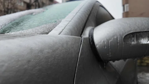 Close up of a car side mirror covered in ice and dripping meltwater 스톡 동영상 329402876