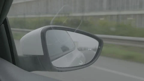 Close-up of a car side mirror driving on the highway Stock Footage 165393979