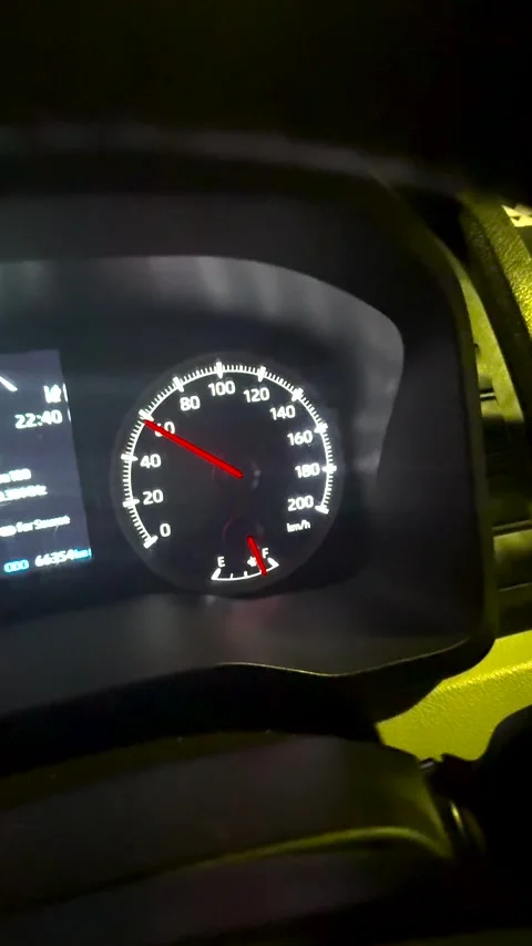 Close-up of a Car Speedometer and Dashboard During Nighttime Highway Driving Stock Footage 324938534