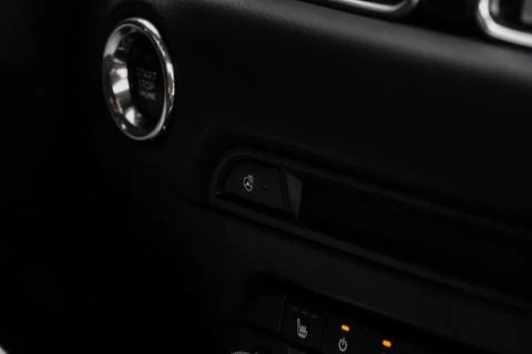 Close up of car steering wheel heating control. Steering wheel heating button Stock Photos