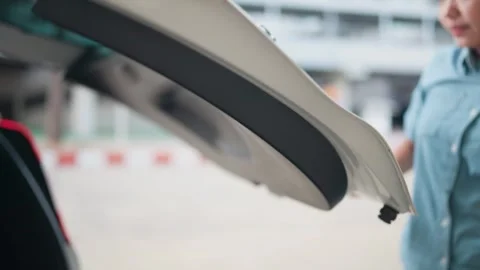 Close-up of a car tailgate or closing a car door with a woman's hand Concept of  Stock Footage 264105493