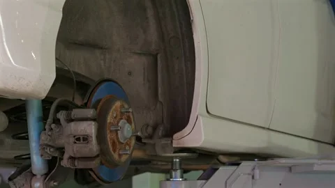 Close-up of car undergoing repair work in garage, focusing on Stock Footage 281666505
