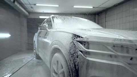 Close up, car washing process. Foaming detergent covers machine, cleans it from Stock Footage 153250025