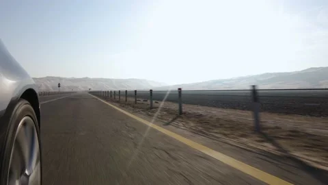 Close-up of a car wheel with camera side mounted driving towards beautiful Stock Footage 142773387