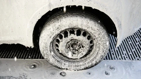 Close-up of a car wheel from which foam is draining Stock Footage 109645928