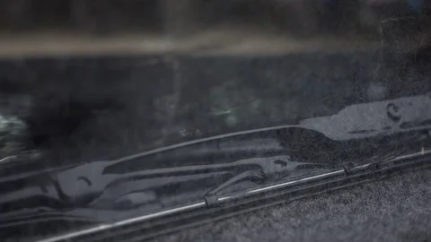 Close-up of car wiper with rain falling and flowing on car windscreen Stock Footage 79692225
