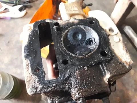 Close-Up of Carbon Deposits and Engine Valve Inside Motorcycle Cylinder Head Stock Photos