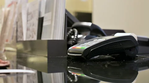 Close-up card reader for credit card payment. Woman's hand tears off a check Stock Footage 104225099