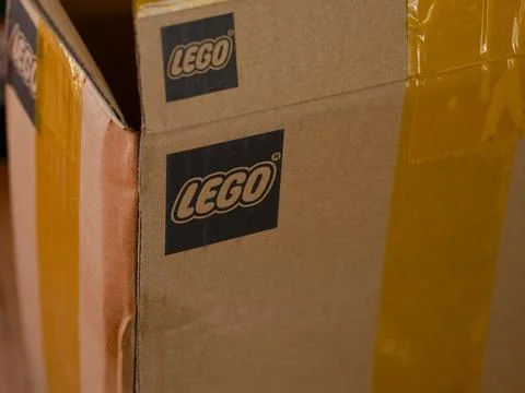 A close-up of cardboard box featuring the printed black Lego logo Stock Photos