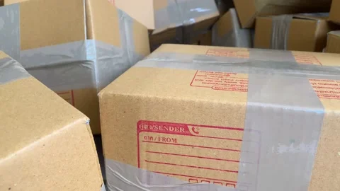 Close up cardboard box package sender and postcode word screen on wrapped parcel Stock Footage 225124855