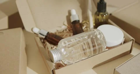 Close up of cardboard boxes with glass bottles, cream tub and toothbrush on Stock Footage 331208207